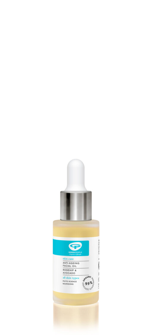 A product photo of Green People's Anti Ageing Facial Oil in a clear dropper bottle, highlighting its organic, plant-based formula with rosehip and avocado. The light yellow oil is visible inside the glass bottle, which has a silver dropper top and a blue and white label.